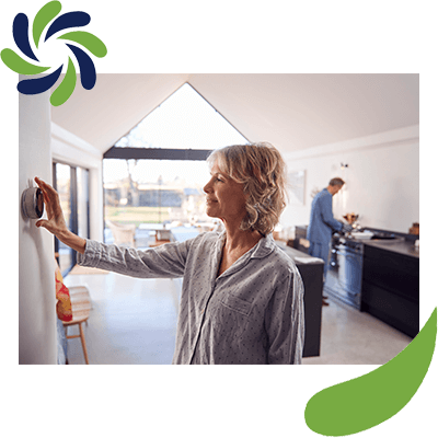 Woman Adjusting Thermostat